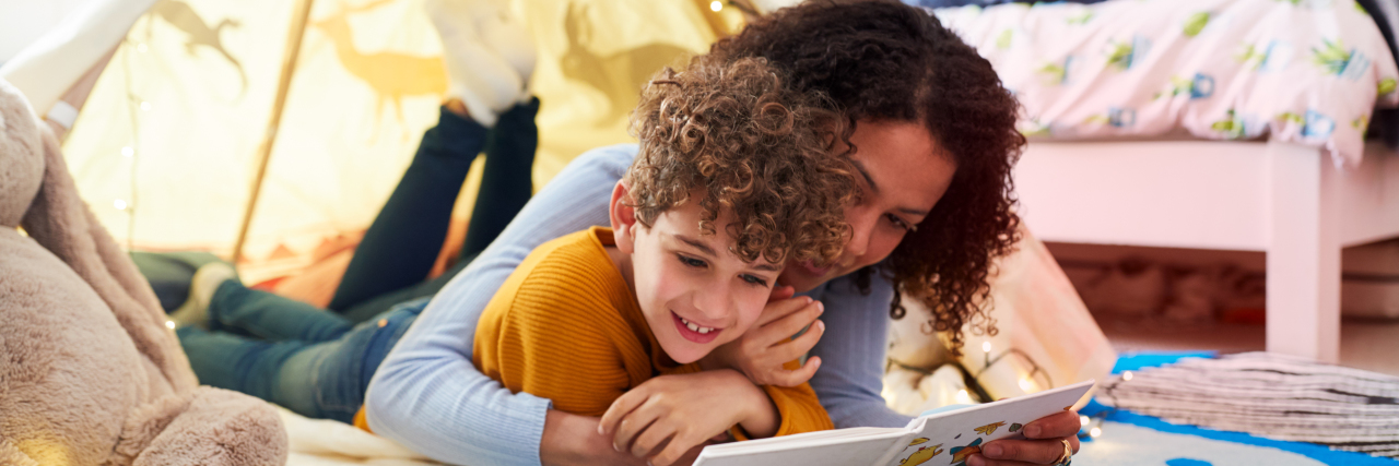 Adventures of the Sensokids Explains Sensory Integration to Families Mom and son reading a book together.