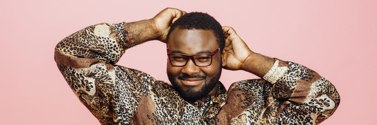 Men Need to Be Included in the Body Positivity Movement Black man looking happy with hands in his hair
