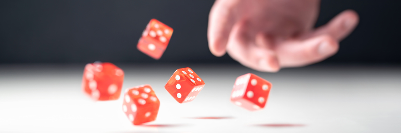 How Ascribing Success to 'Hard Work' Hurts People With Chronic Illness Hand throwing and rolling dice.