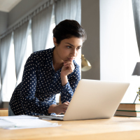 Young woman working on computer from home.