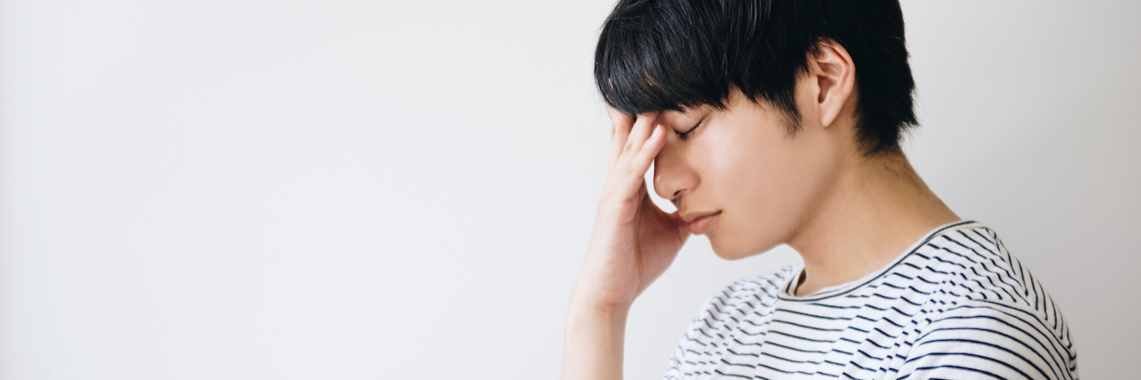 Why I'm Scared to Get Botox for Tardive Dyskinesia A man with his head down