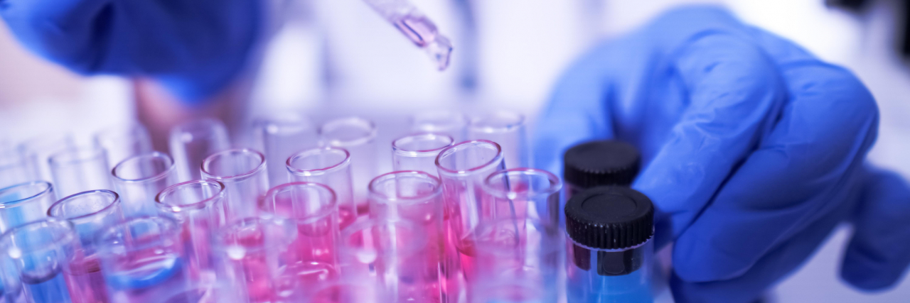 ‘Bureaucratic Idiocy’: FDA Faces Bipartisan Pressure on Rare Disease Drugs female lab technician doing research with a microscope in the lab.