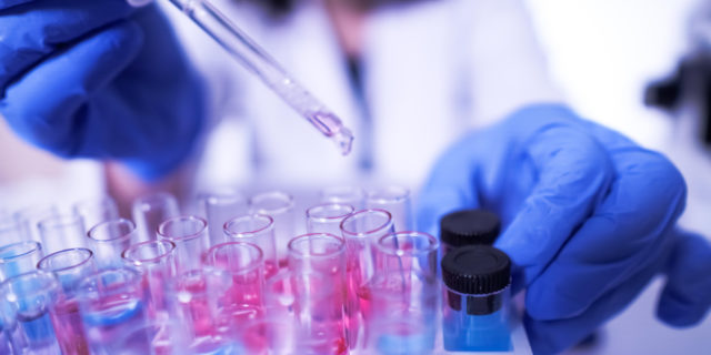 ‘Bureaucratic Idiocy’: FDA Faces Bipartisan Pressure on Rare Disease Drugs female lab technician doing research with a microscope in the lab.