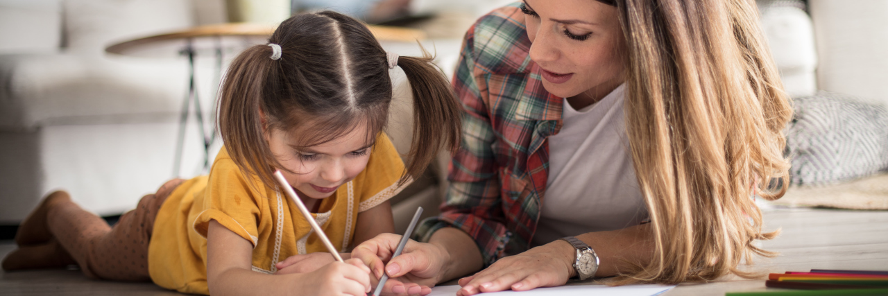 Supporting My Child With ADHD and Sensory Processing Disorder Mom helping daughter with homework.