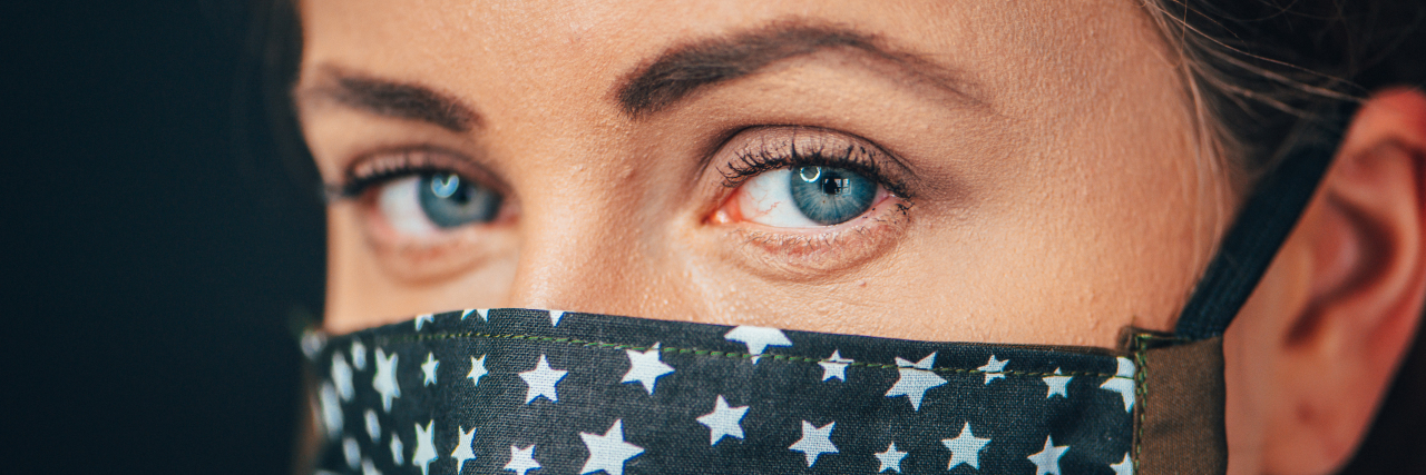 My COVID-19 Fears as a Chronically Ill Person Are Valid Woman wearing cloth mask with stars.