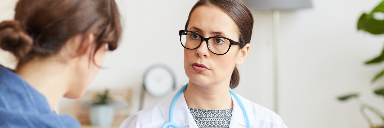 Experiencing Grief After a Rare Disease Diagnosis Young female doctor in white coat talking to her patient while visiting her
