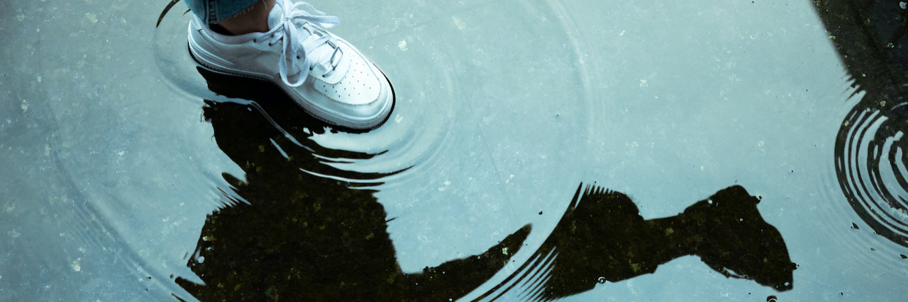 How Dialectical Thinking Has Helped My BPD A white sneaker stepping in a rain puddle