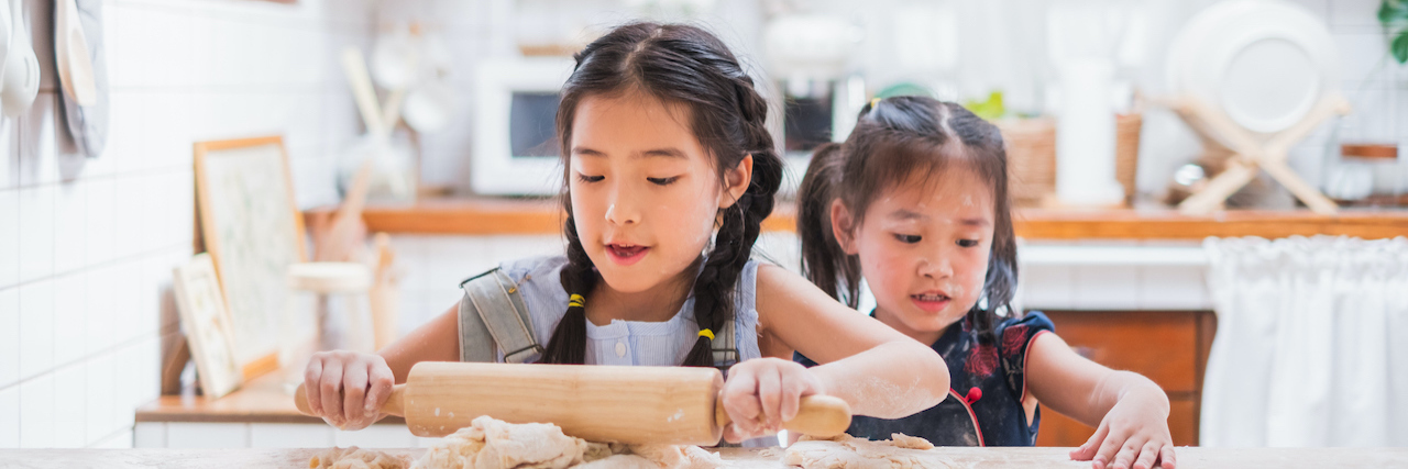 What I'm Learning About Grief After Losing My Sister Two young girls baking in the kitchen