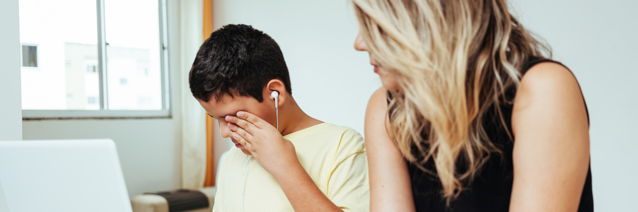 Supporting Children Who Struggle With Virtual Learning During COVID-19 Mother helping sad son with homework.