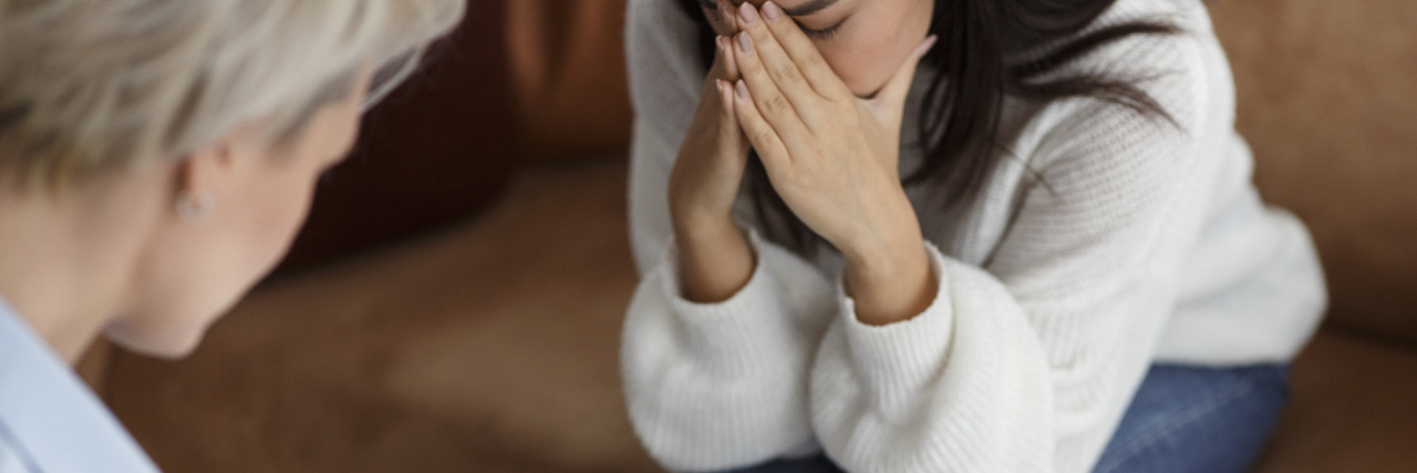 close up photo of woman crying in therapy