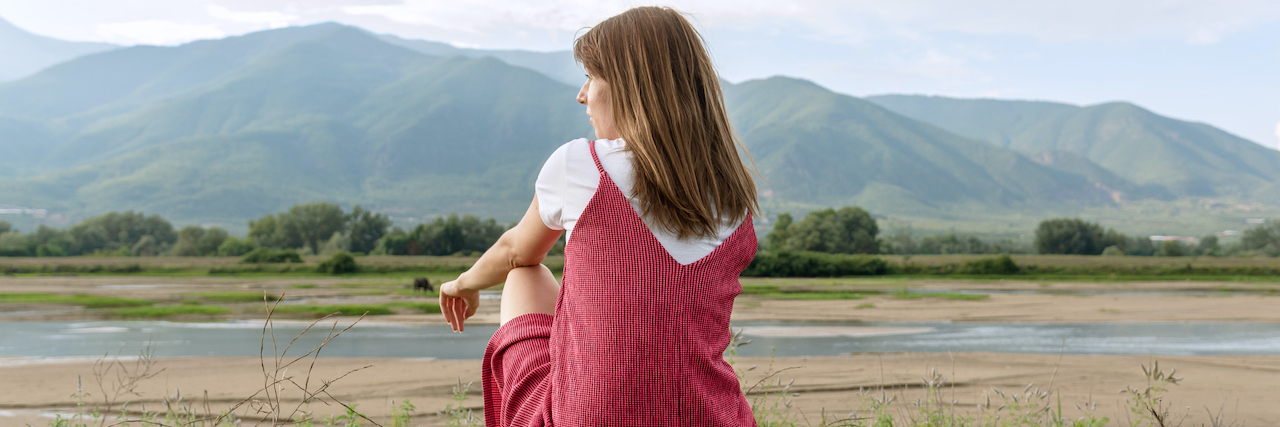 To the Woman Who Called My Self-Harm Scars Disgusting A woman sitting by the river