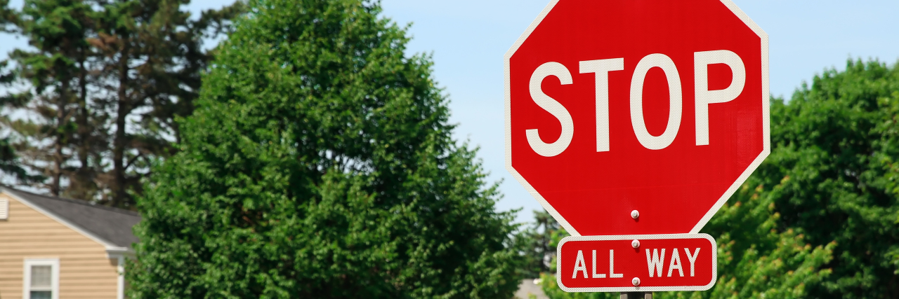 The Problem With Saying 'My Chronic Illness Doesn't Stop Me' Stop sign.