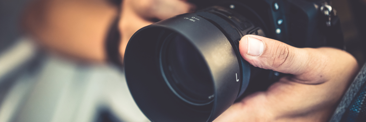 Photography With a Movement Disorder Man using a camera.