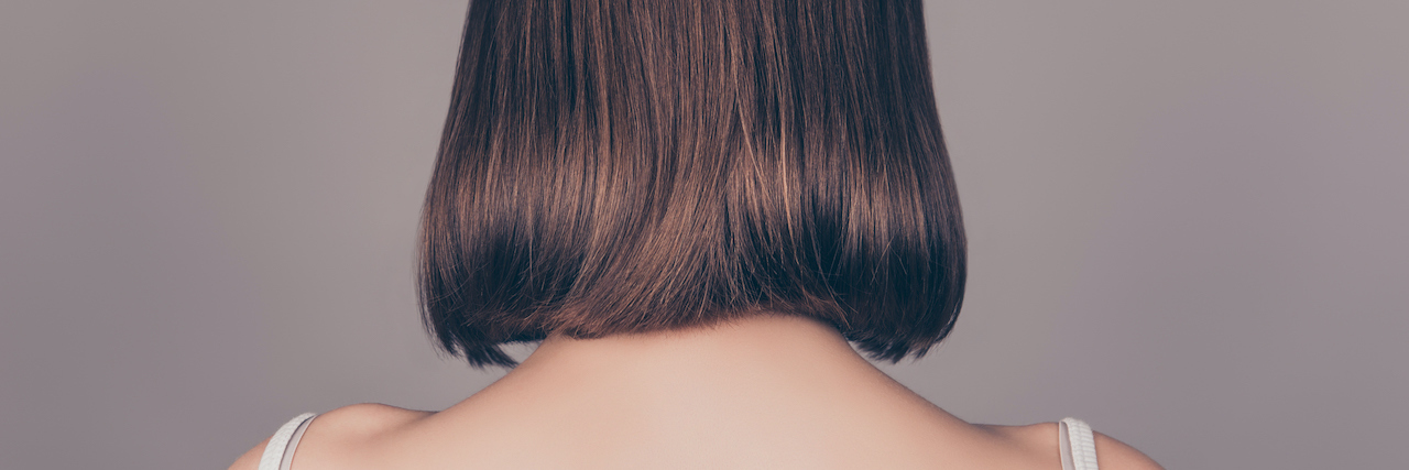 What It's Like To Donate Your Hair For The First Time Back view of of woman with medium length hair