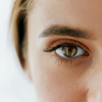 close up of a woman's eyes, which are brown