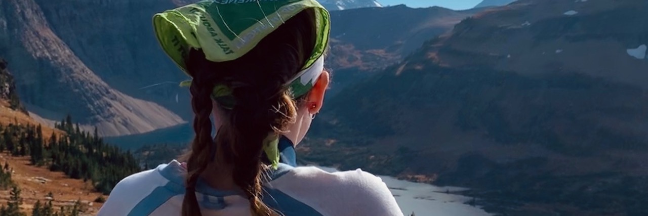 The Pain of Losing a Friend to Suicide When You're Suicidal A woman looking out on a mountain