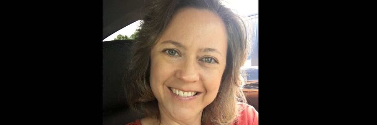 Processing Grief After My Double Mastectomy a woman is smiling at the camera