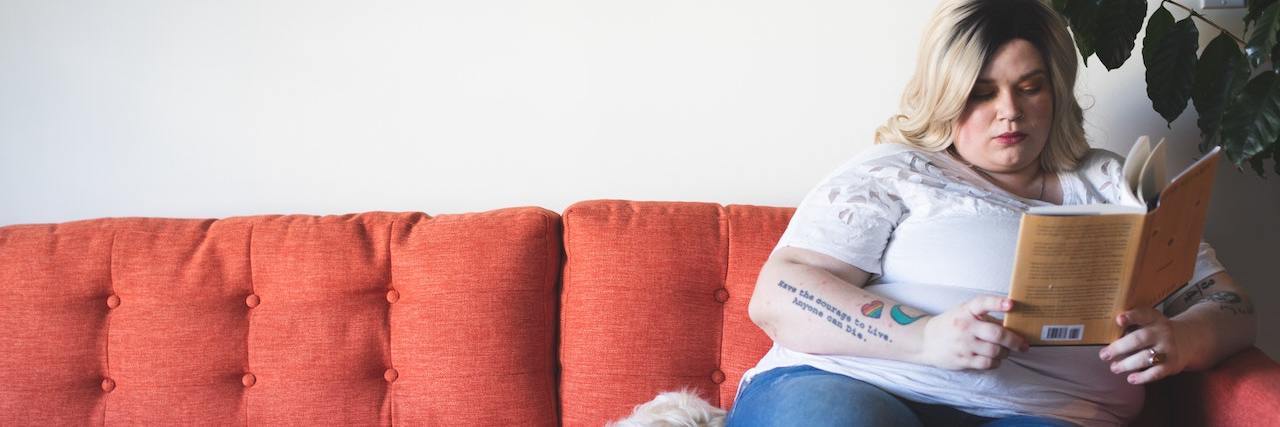 How Weight Bias Affects People Living With Chronic Pain A woman sitting on the couch