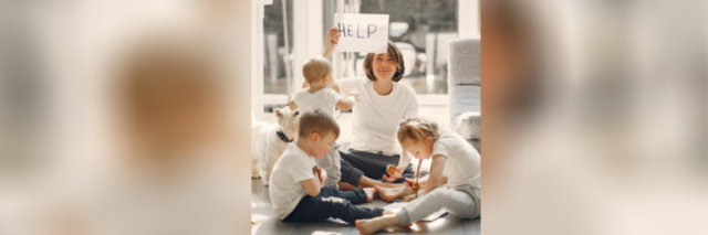 Woman with young children holding a sign that says "help"
