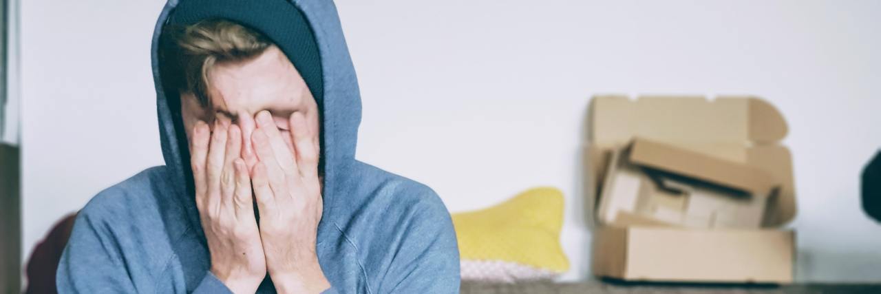 The Differences Between a Toxic Relationship and an Abusive One person sitting with hands over face
