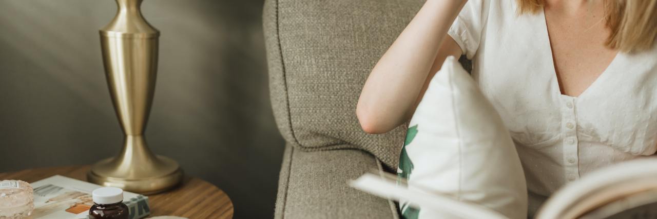 What to Do When You Leave Work Due to Mental Illness photo of woman sitting on sofa reading a book