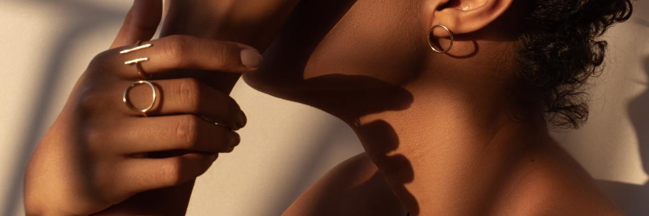 15 Ways to Support a Friend With Chronic Illness Who’s Struggling Black woman sitting with hand hiding her face