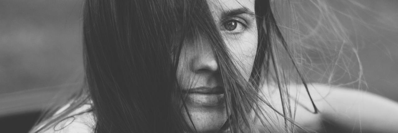 When Mental Health Treatment Is Traumatizing A woman looking, her hair in her face