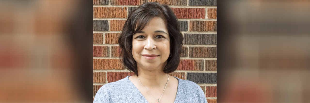 Searching for Meaning in Breast Cancer Treatment During COVID-19 Headshot of the contributor standing in front of a brick wall
