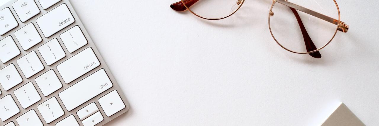 Grieving Losing the Ability to Work Due to Schizoaffective Disorder computer keyboard and reading glasses.