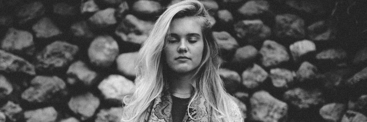 How Do You Stop Being Numb and Feel Again? black and white photo of young woman facing camera with eyes closed