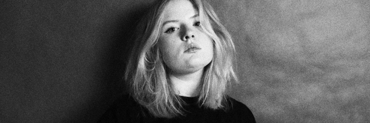 What to Know About Getting a Childhood Bipolar Disorder Diagnosis black and white photo of young woman who looks moody or unhappy