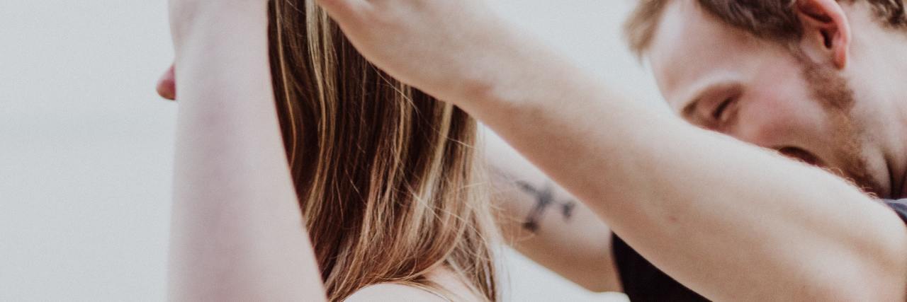 First Date Ideas Without Food for Eating Disorder Recovery photo of young man and woman with their hands linked, woman in front of man and facing away