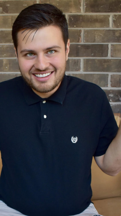 a young man with autism smiling at the camera.