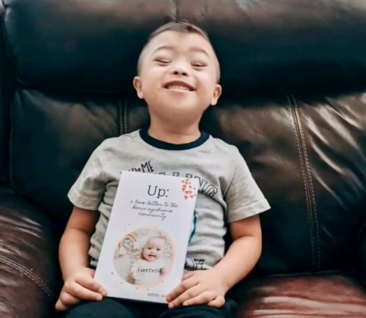 Nathan holding Ashley's book.