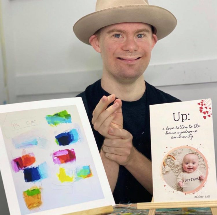 Charlie French with my book Up: A Love Letter to the Down Syndrome Community 