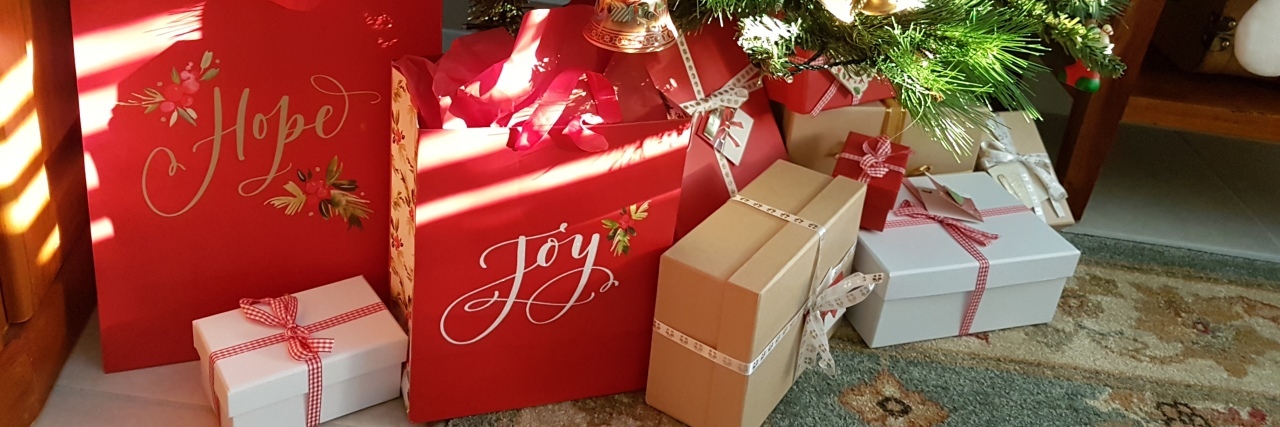 Tips for Decorating and Celebrating Christmas With Chronic Illness Presents under a Christmas tree.