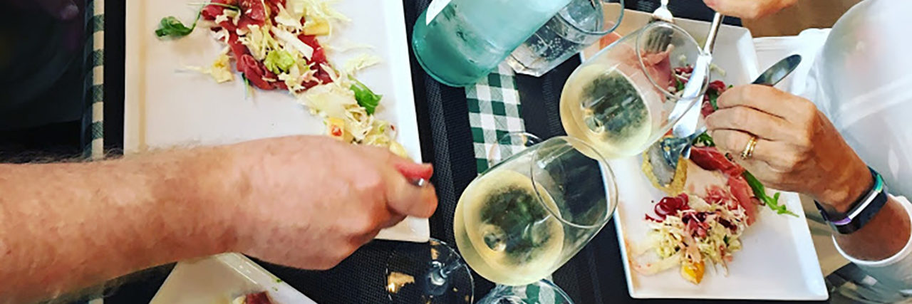 Making This Quiet Holiday Season a Blessing for Neurodiverse Families Family eating a meal together.