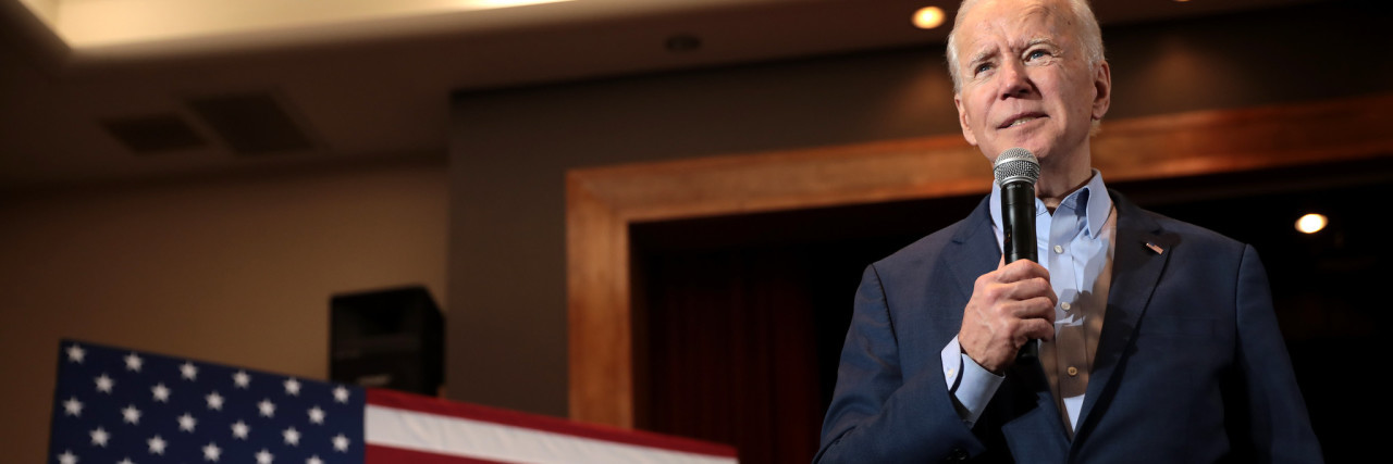 What to Know About President-Elect Joe Biden's Plans for Mental Health Flickr image from Gage Skidmore, showing President-Elect Joe Biden with a microphone standing beside an American flag