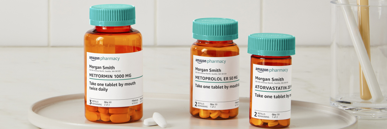 Collection of pill bottles with Amazon Pharmacy branding on their labels