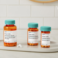 Collection of pill bottles with Amazon Pharmacy branding on their labels