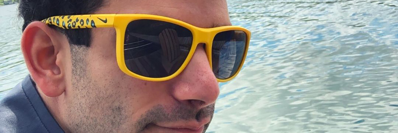 What Epilepsy Looks Like Through My Eyes Kyle wearing sunglasses and riding in a boat.