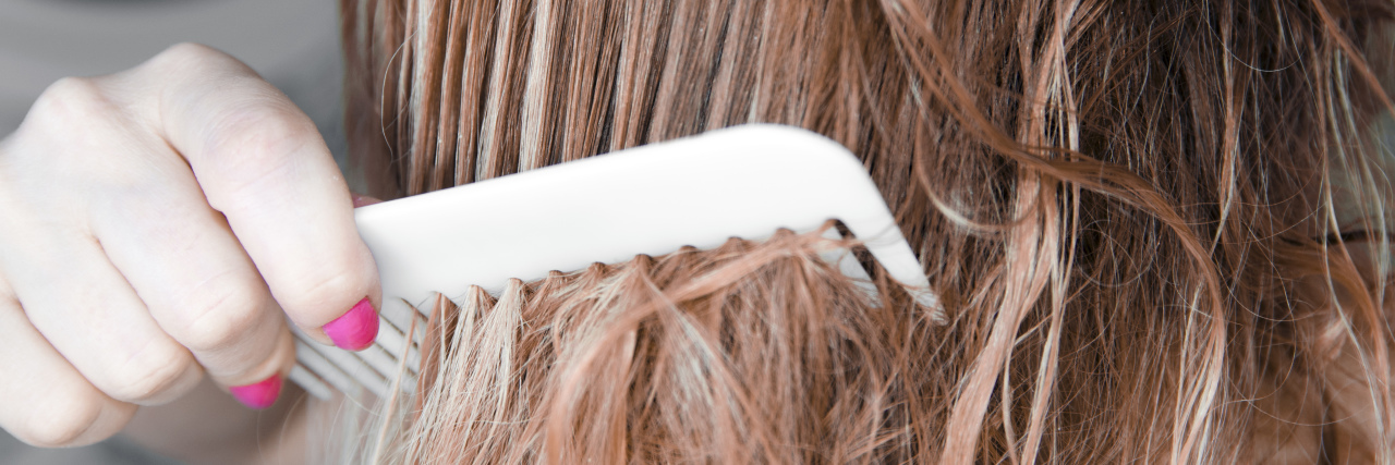 When People Dismiss My Fibromyalgia Pain Sensitivity Young woman brushing her hair.