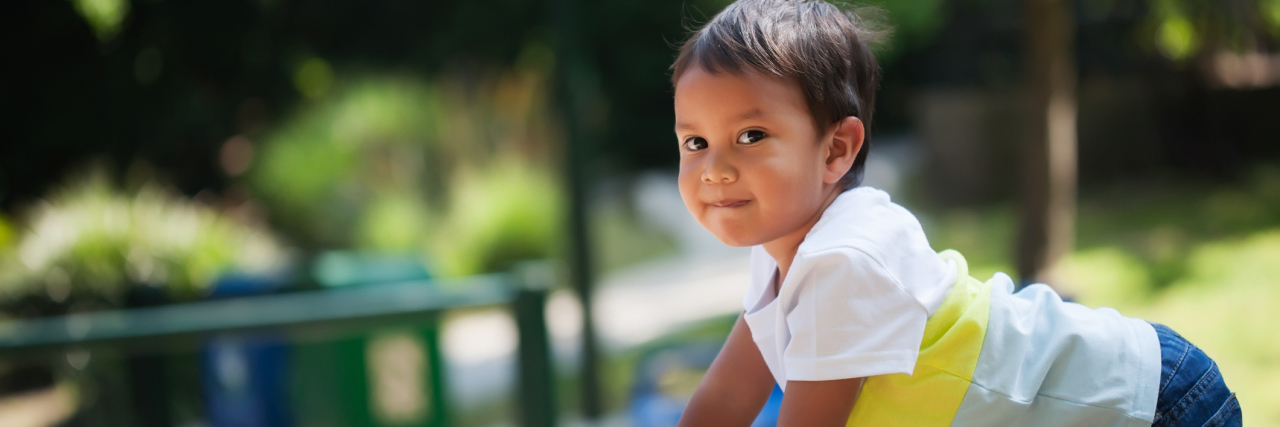 Screening for Developmental Disabilities Lags in California Young boy climbing something in a kids playground park during sunset