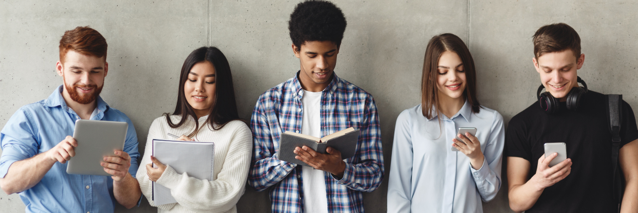 What True Inclusion Means to Me as a Neurodiverse Student Diverse students with books standing near grey wall.