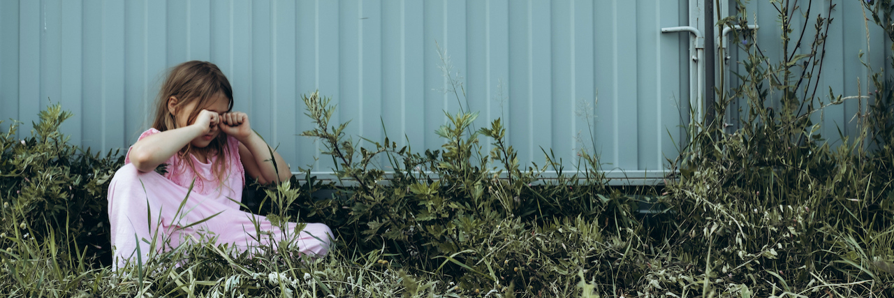 Growing Up Without Unconditional Love From Your Mother Little sad girl crying alone outdoor.