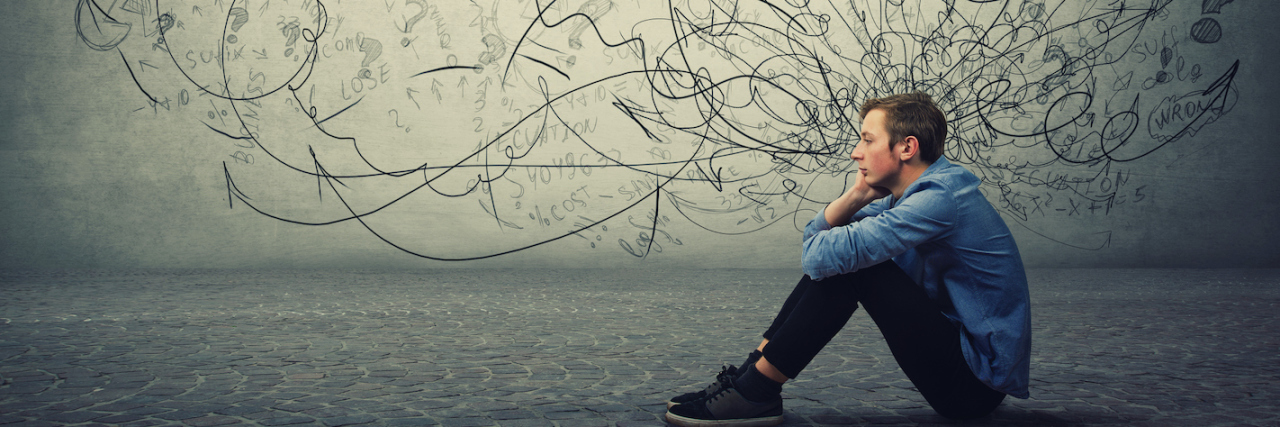 A boy sitting on the ground in deep thought, lines coming out of his head