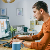 Man working from home on computer.