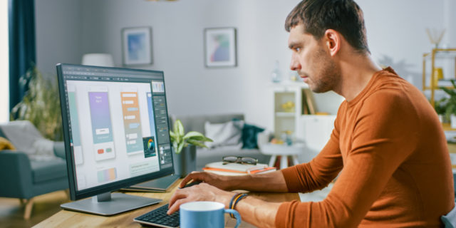 Why Autism Workplace Accommodations Need to Be Fluid Man working from home on computer.