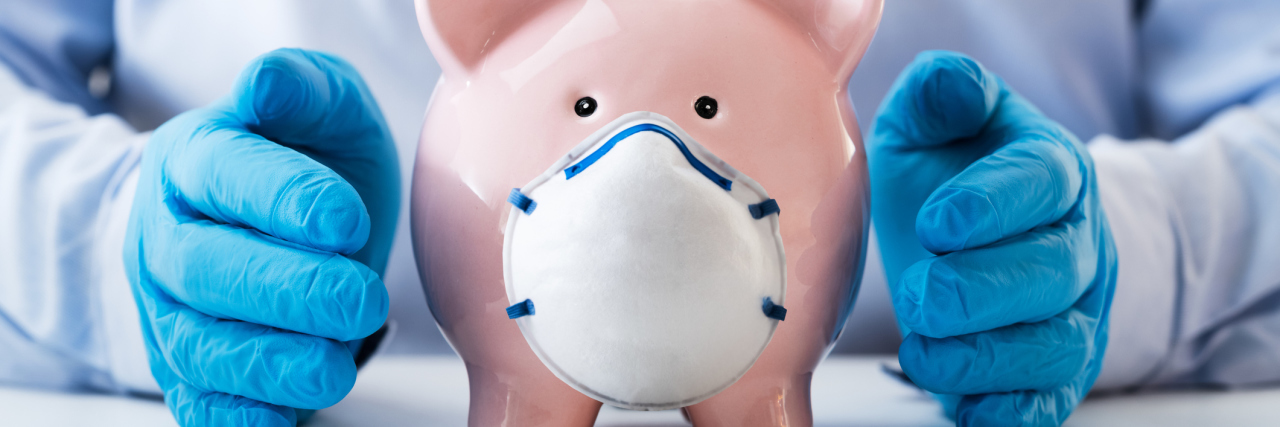 piggy bank with a surgical mask on it, gloved hands on either side