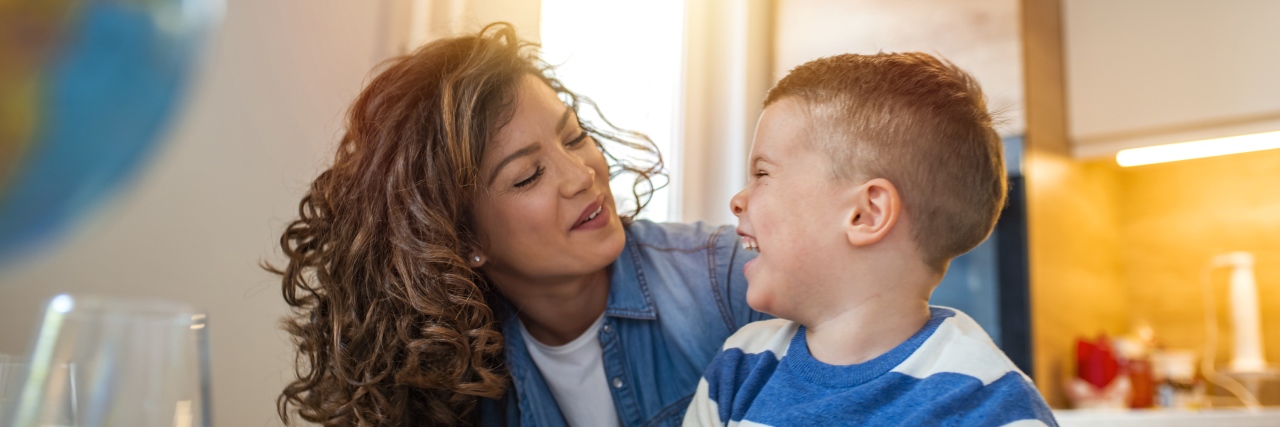 Adjusting to Parenting a Child on the Autism Spectrum a mother helping her son with school work